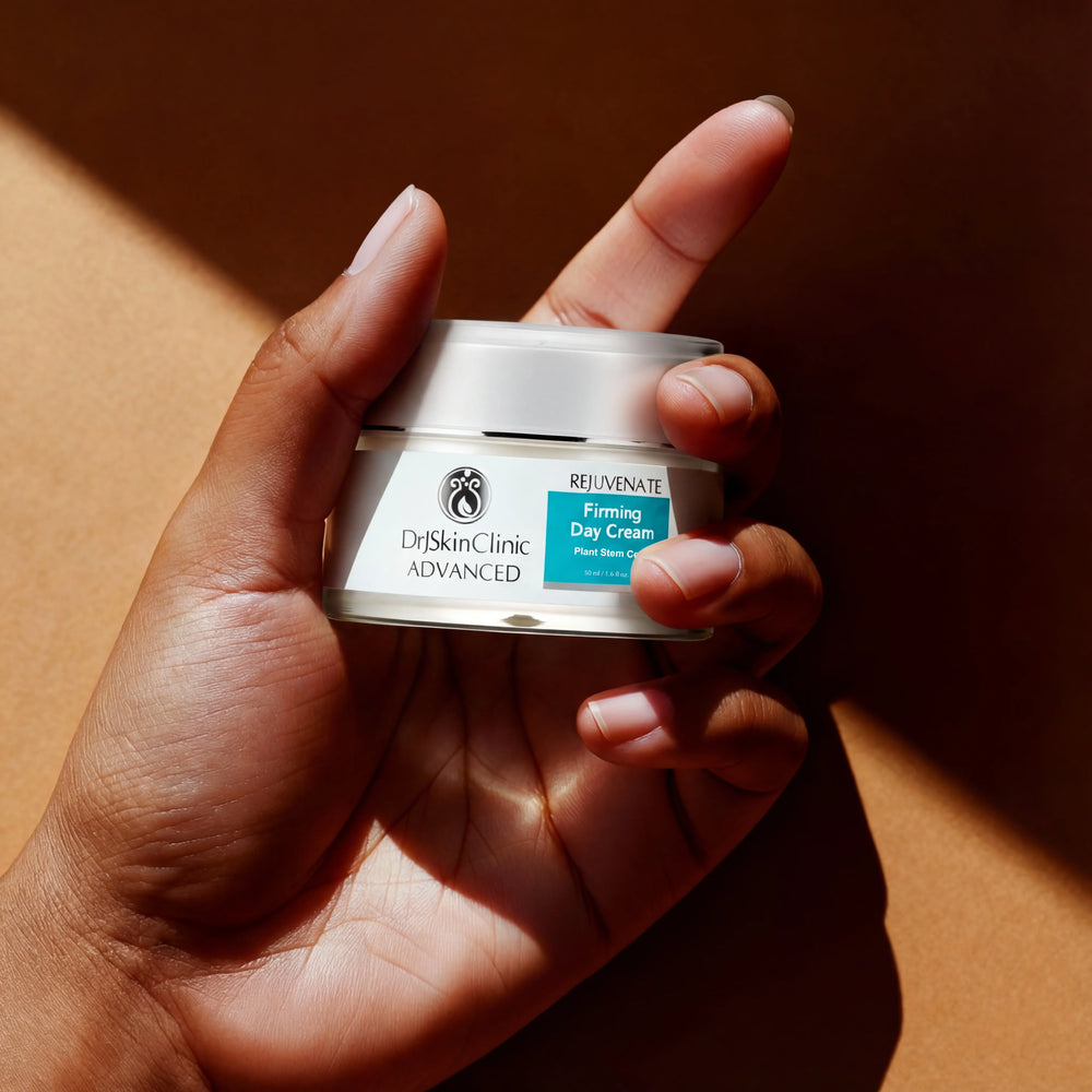 Hand holding a jar of DrJSkinClinic Advanced Firming Day Cream against a brown background