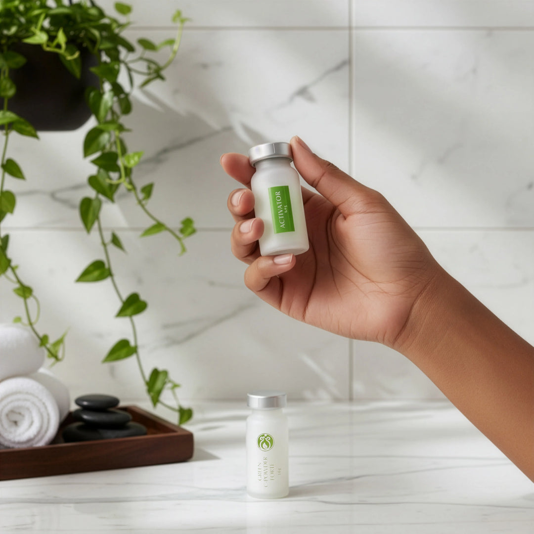 Hand holding DrJSkinClinic Green C-Powder Forte Kit activator bottle, demonstrating professional vitamin C skincare application