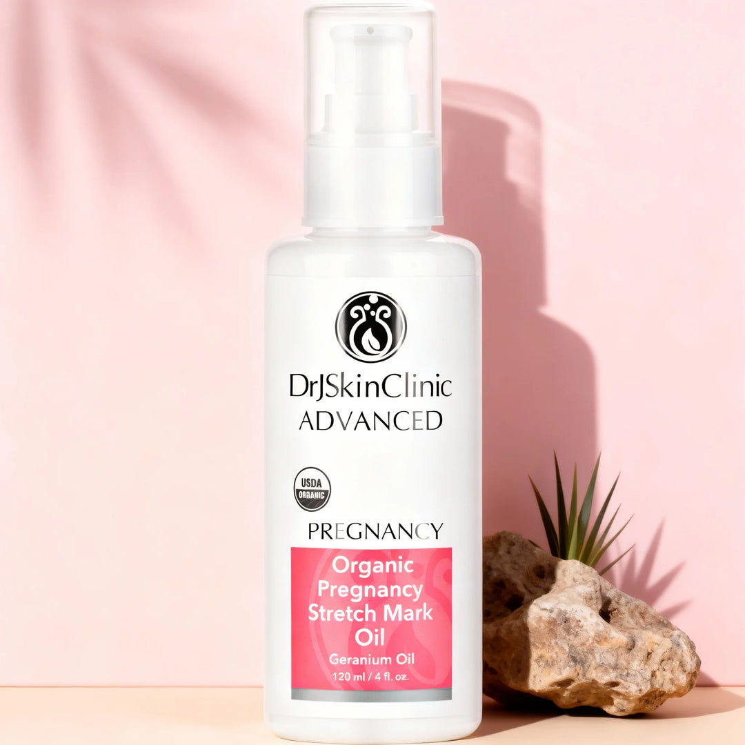 Dr Skin Clinic Advanced Organic Pregnancy Stretch Mark Oil bottle on a pink background with a plant and rock.