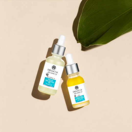 DrSkinClinic Advanced Organic Rejuvenating Oil and Rejuvenating Eye Repair Serum in glass dropper bottles on a beige background with a green leaf