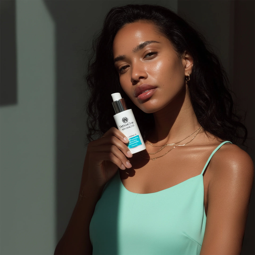 Model holding DrSkinClinic Advanced Skin Protective Recovery Concentrate serum, showcasing radiant healthy skin in natural light