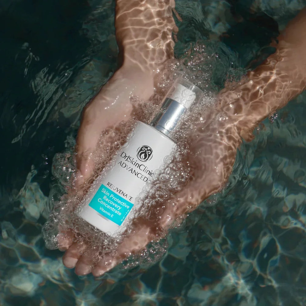DrSkinClinic Advanced Skin Protective Recovery Concentrate serum held in hands underwater, highlighting hydrating and skin-repair benefits