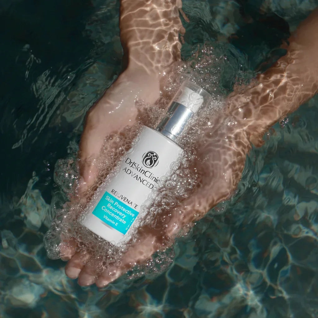 DrSkinClinic Advanced Skin Protective Recovery Concentrate serum held in hands underwater, highlighting hydrating and skin-repair benefits